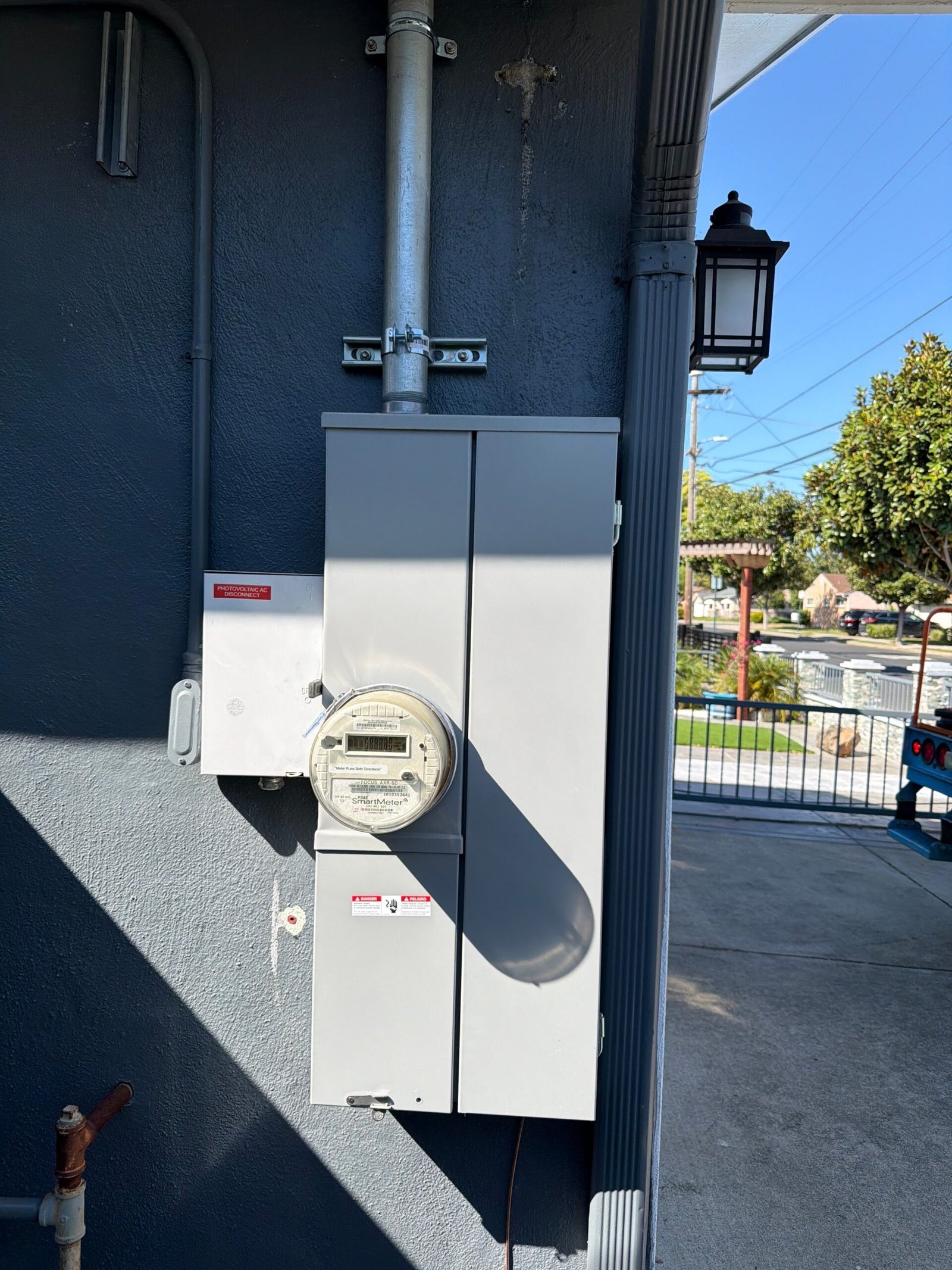 Photovoltaic AC disconnect and smart meter installed on exterior wall