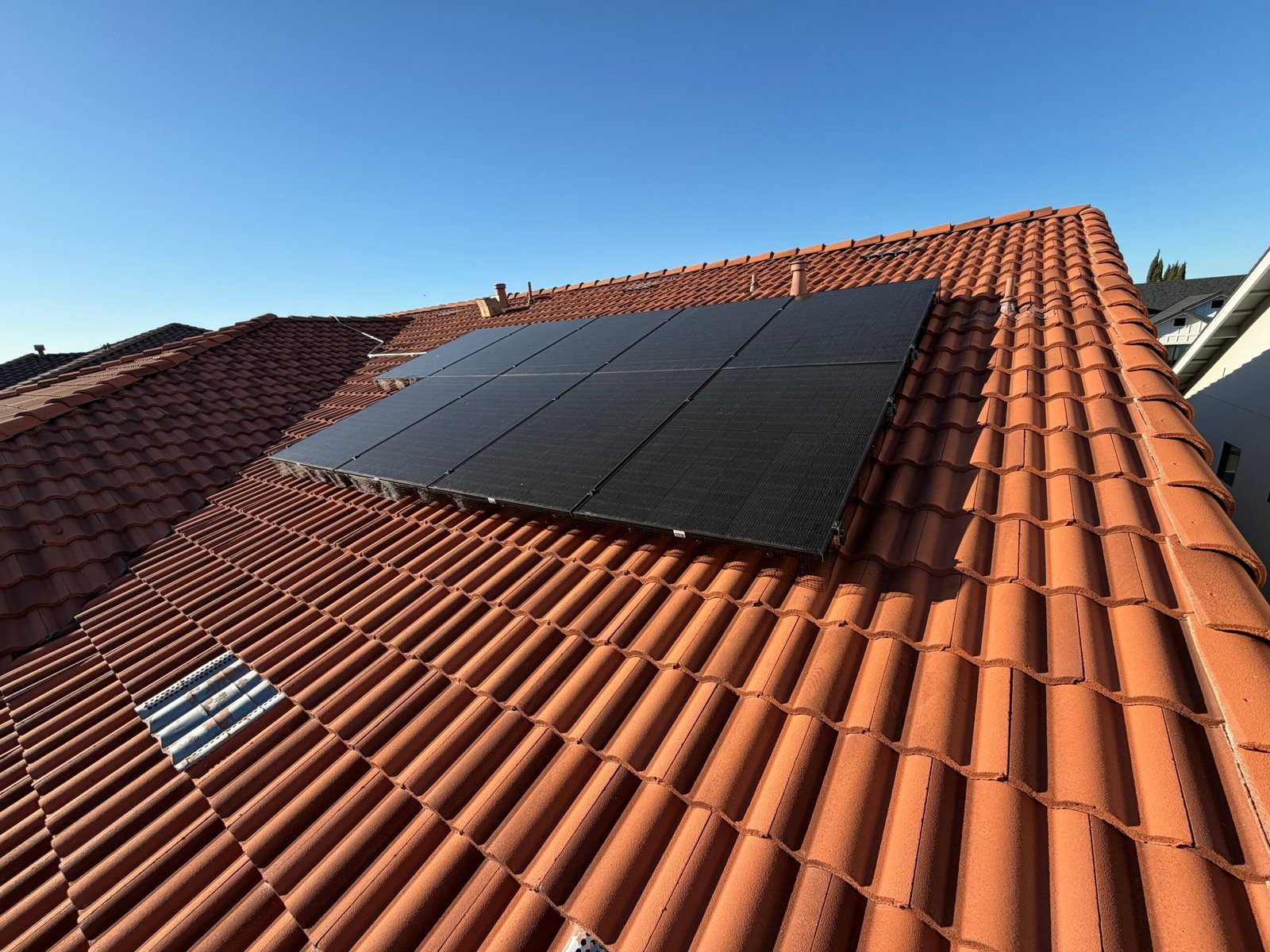 Solar panels installed on a terracotta tile roof