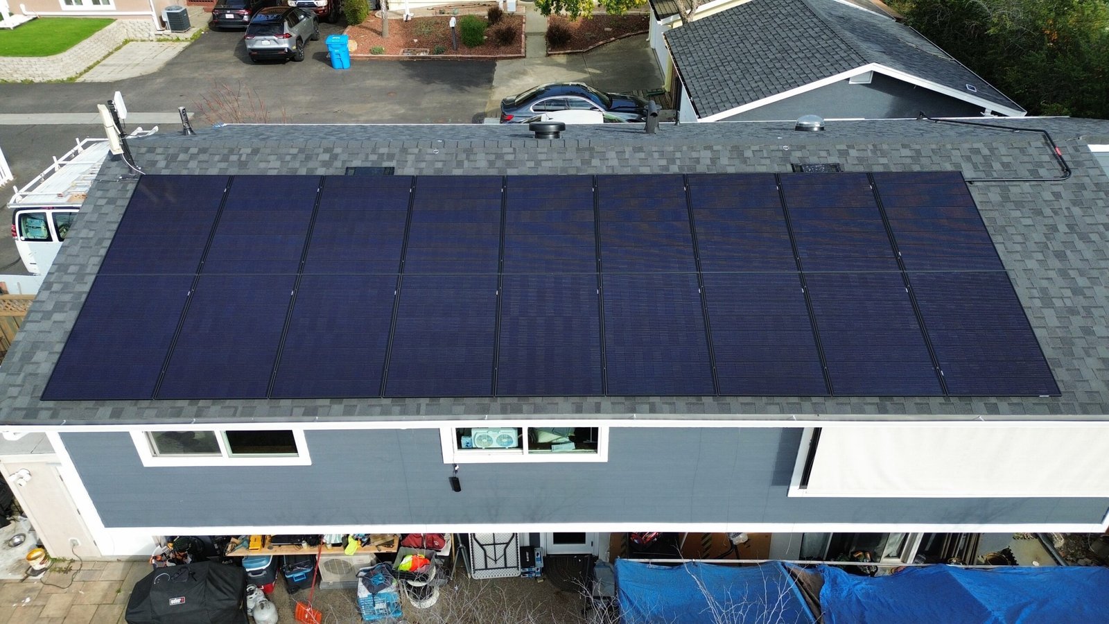 Aerial view of a complete rooftop solar system on a residential home